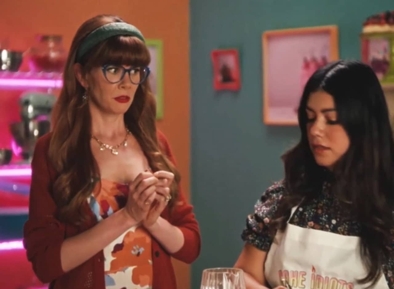 host looking concerned toward a baker contestant