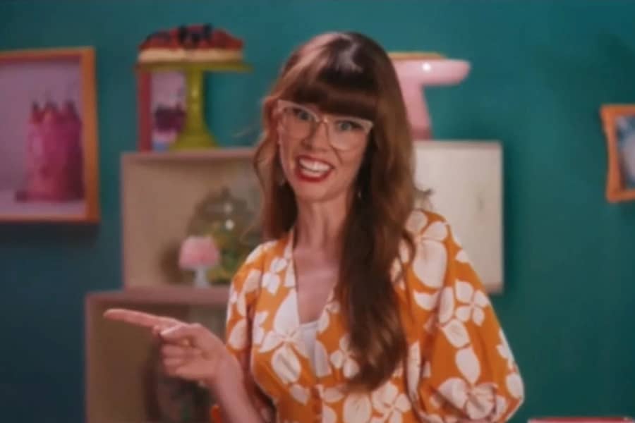 host smiling and pointing