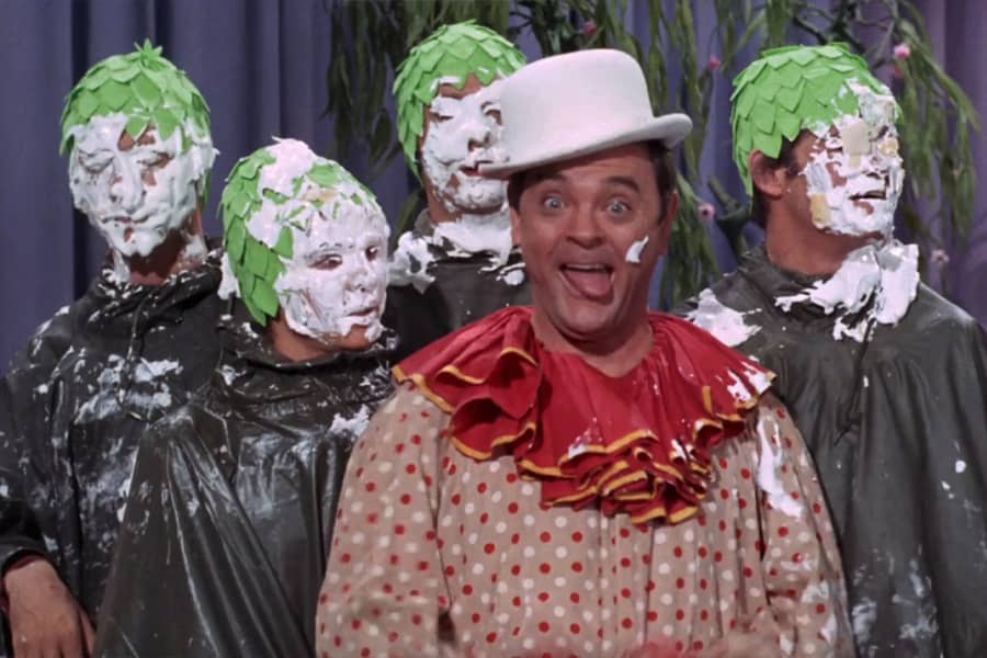 Captain Crocodile in front of The Monkees who have cream pies all over their faces