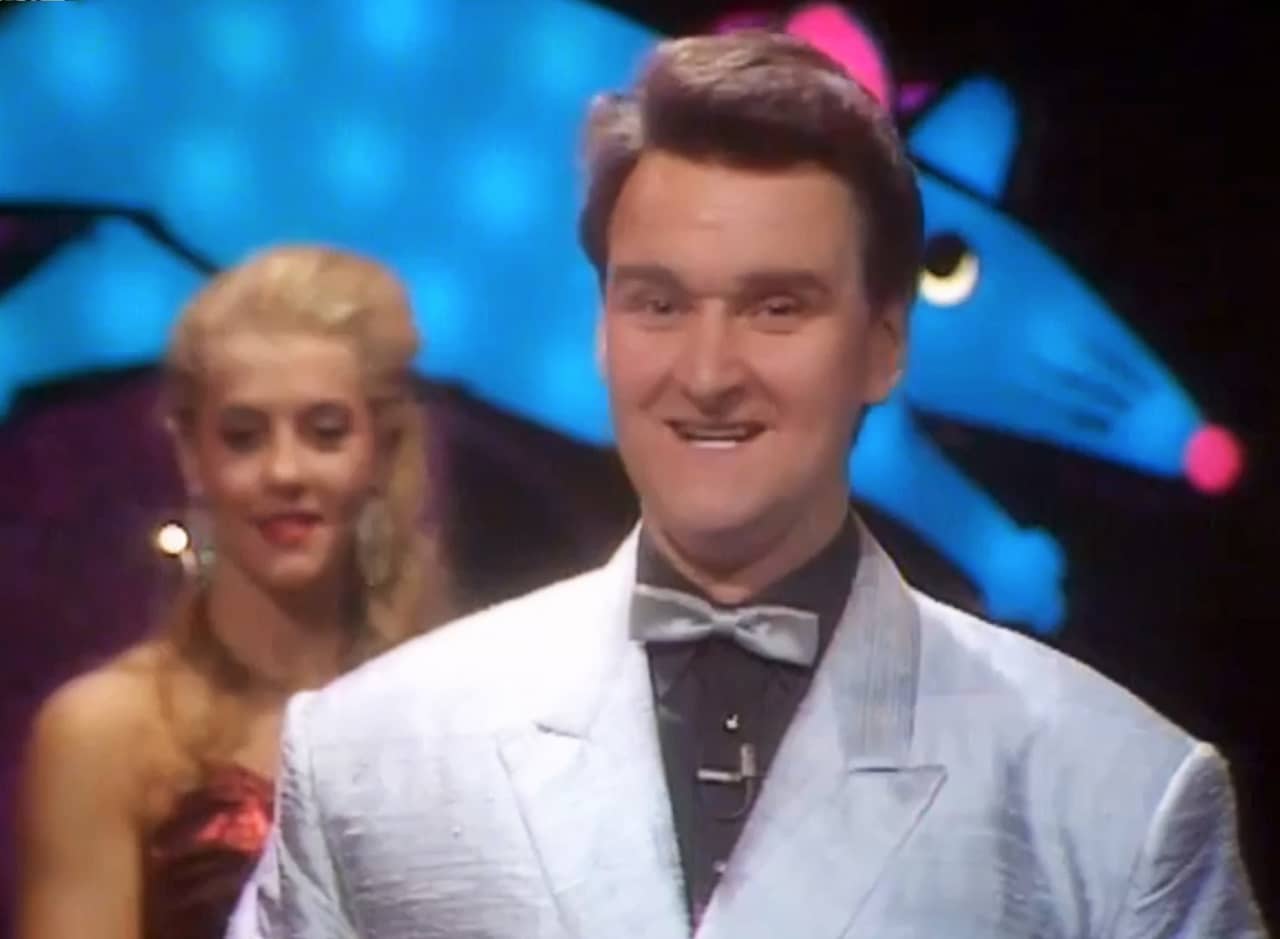 host Dave Right in a silver suit