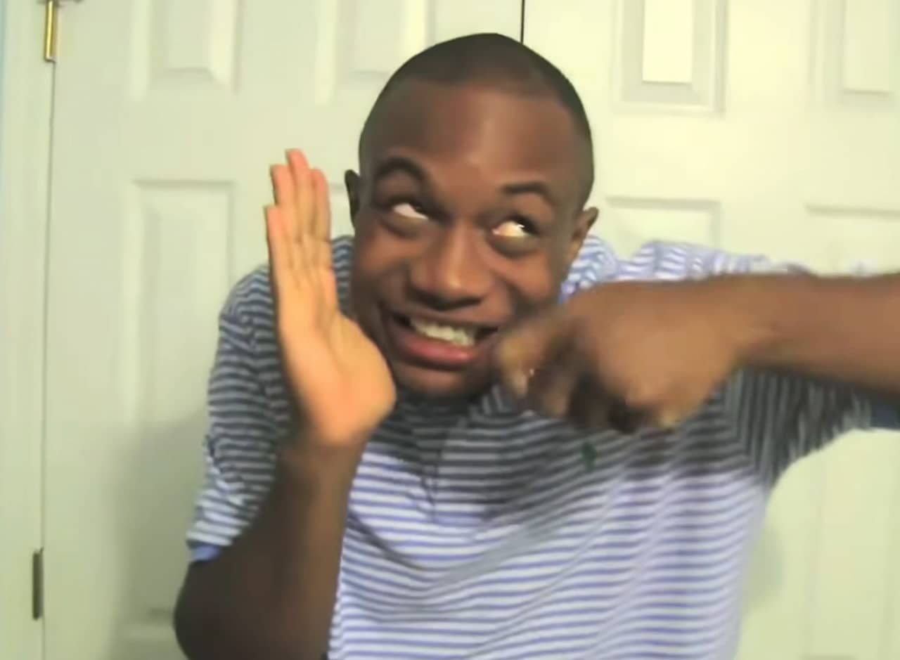 Charley, a young Black man, pretending to eat cereal with a smile