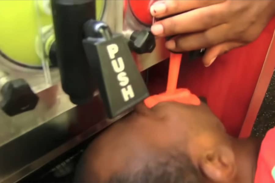 Charley at a gas station, pouring slurpee into his mouth directly from the machine