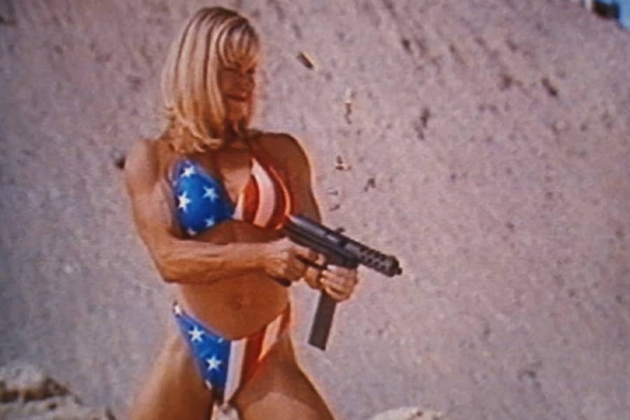 the blonde woman shooting the TEC-9