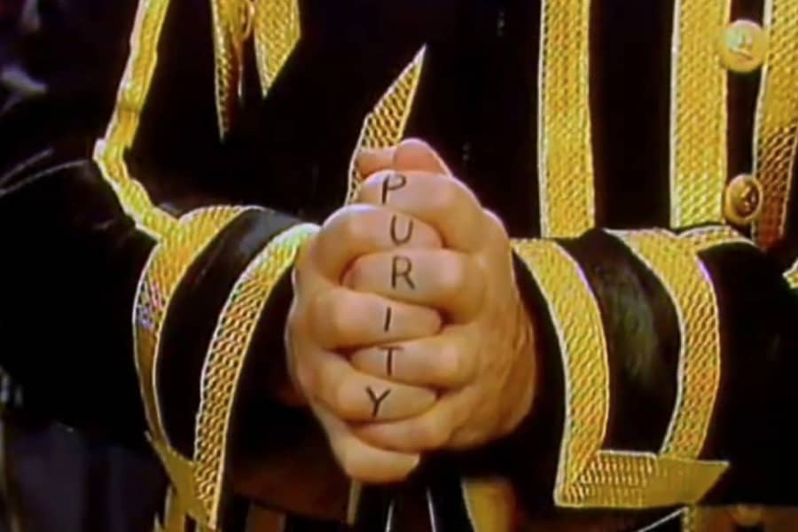 Damsar’s fingers crossed spell out “Purity”