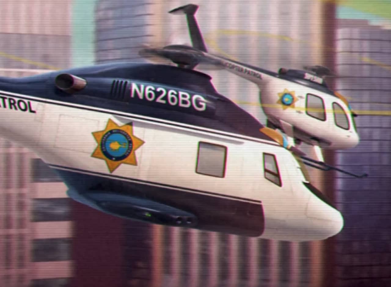 two police choppers flying between skyscrapers
