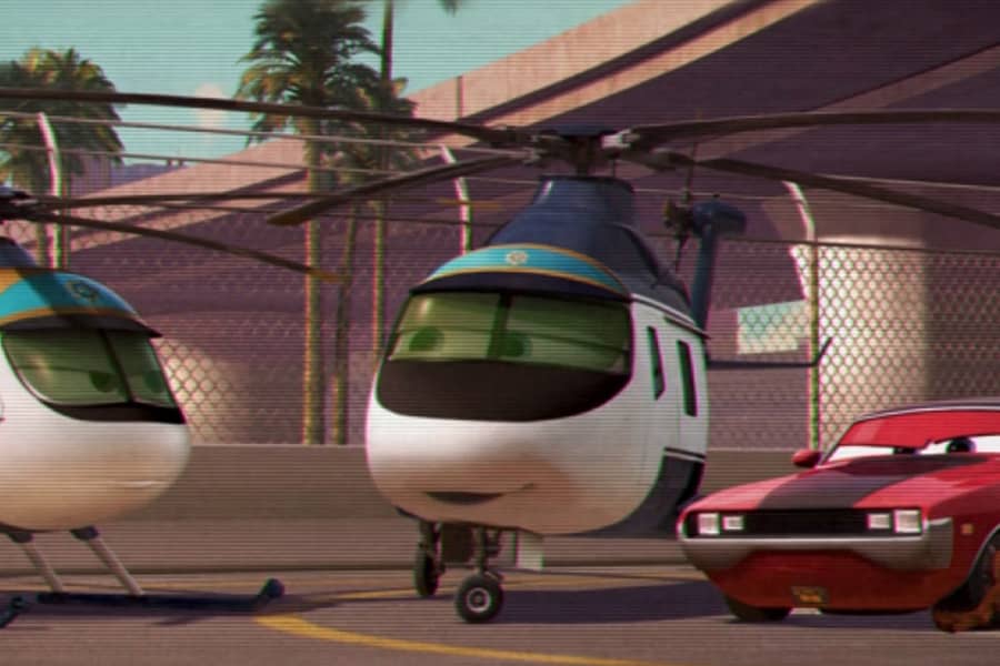 two choppers talking with a red sports car