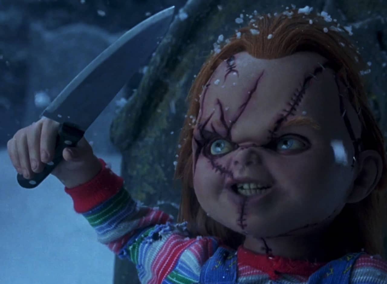 Chucky the doll holds up a knife