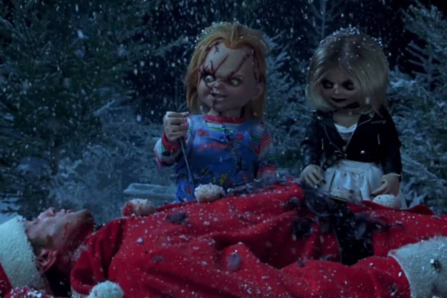 Chucky and Tiffany stand over the dead Santa