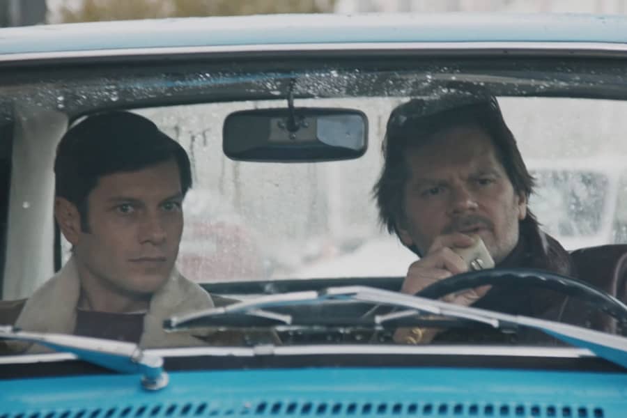 Gregor in the car on a stakeout with his partner