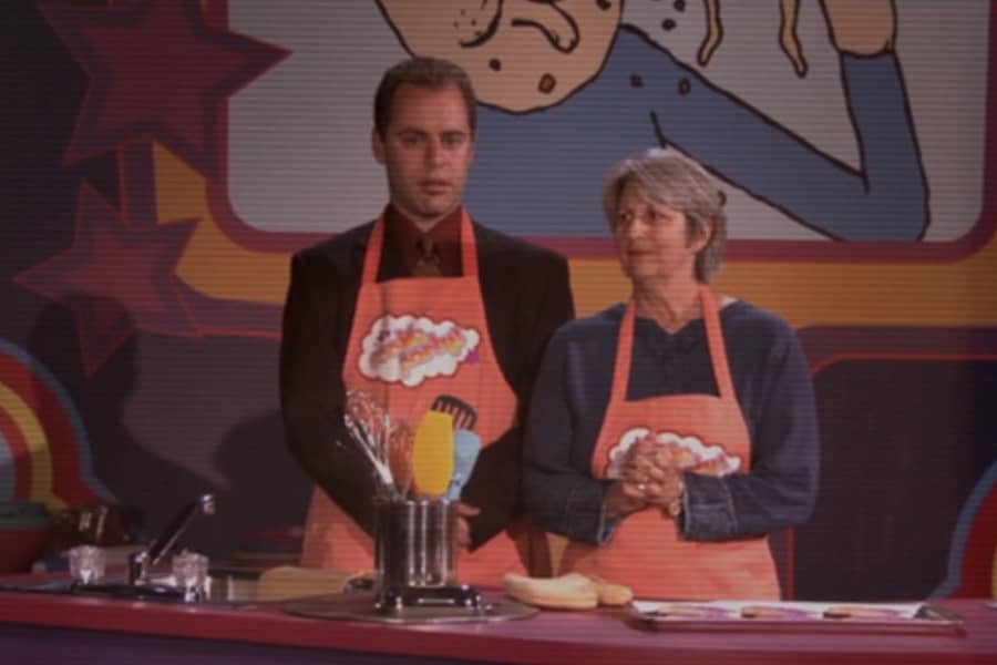 a man and woman in orange aprons