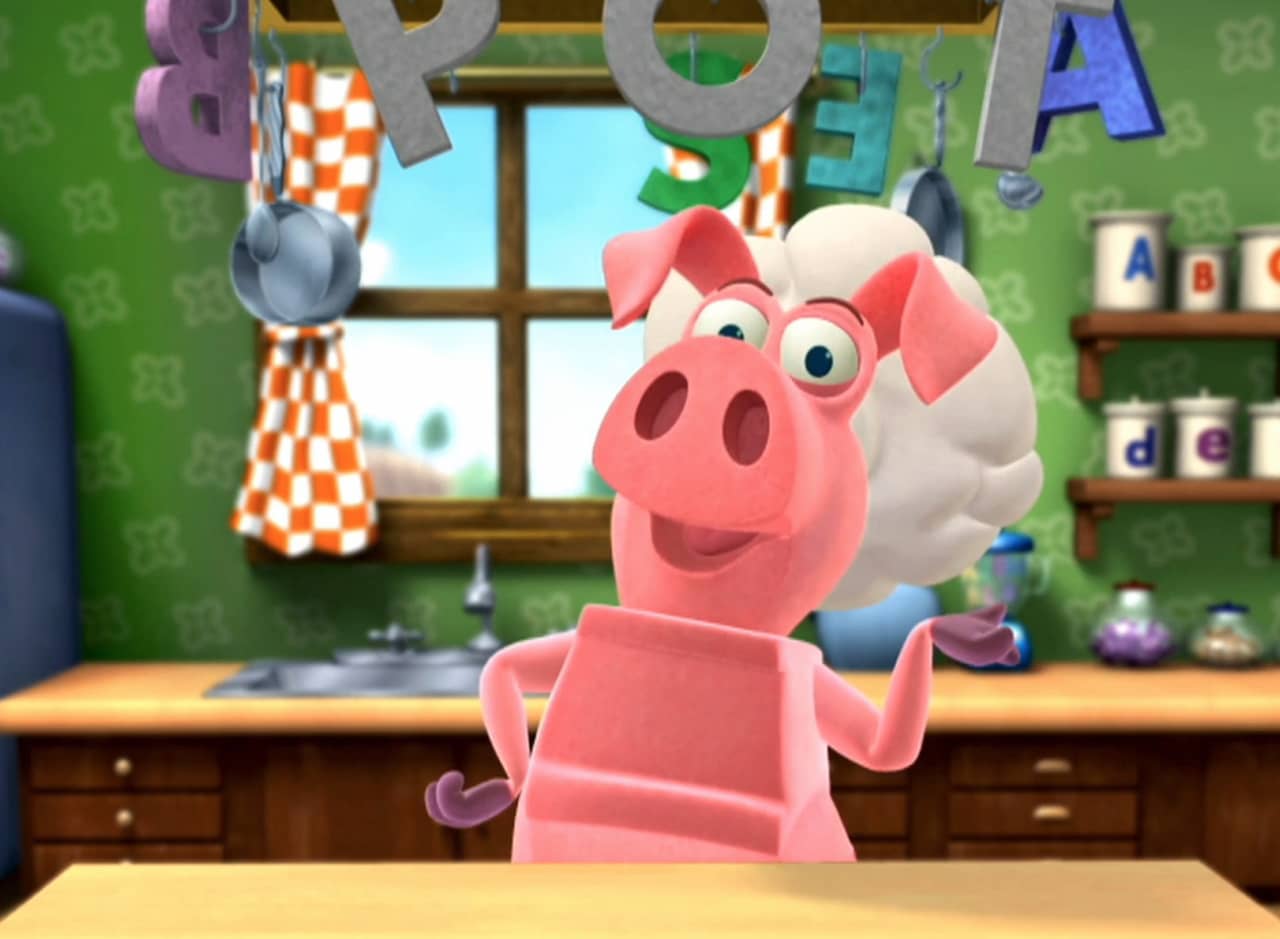Pig wearing a chef’s hat in a kitchen