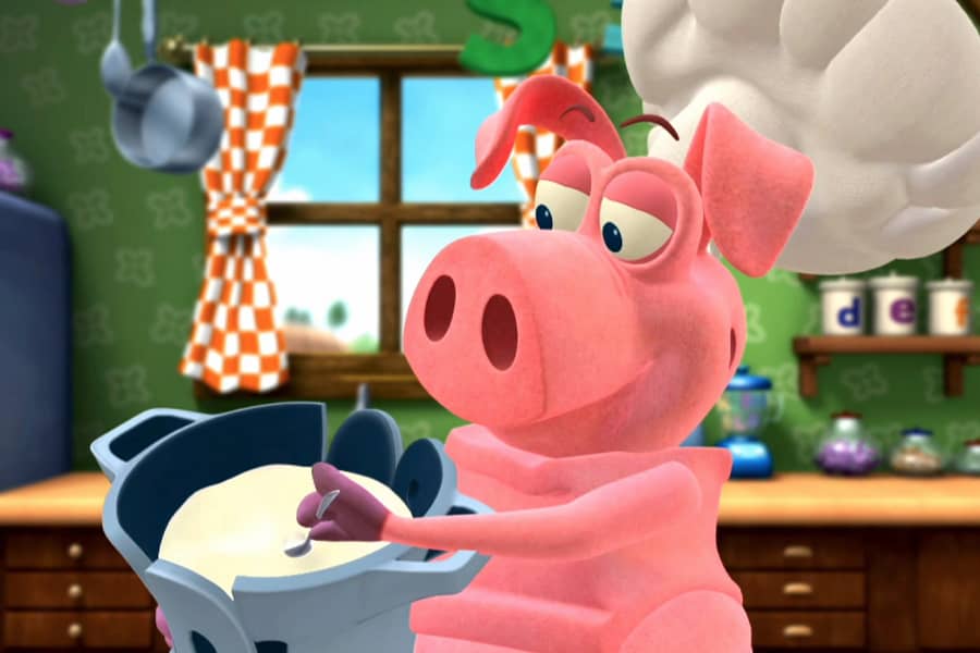 Pig putting a spoon into the pot full of white food