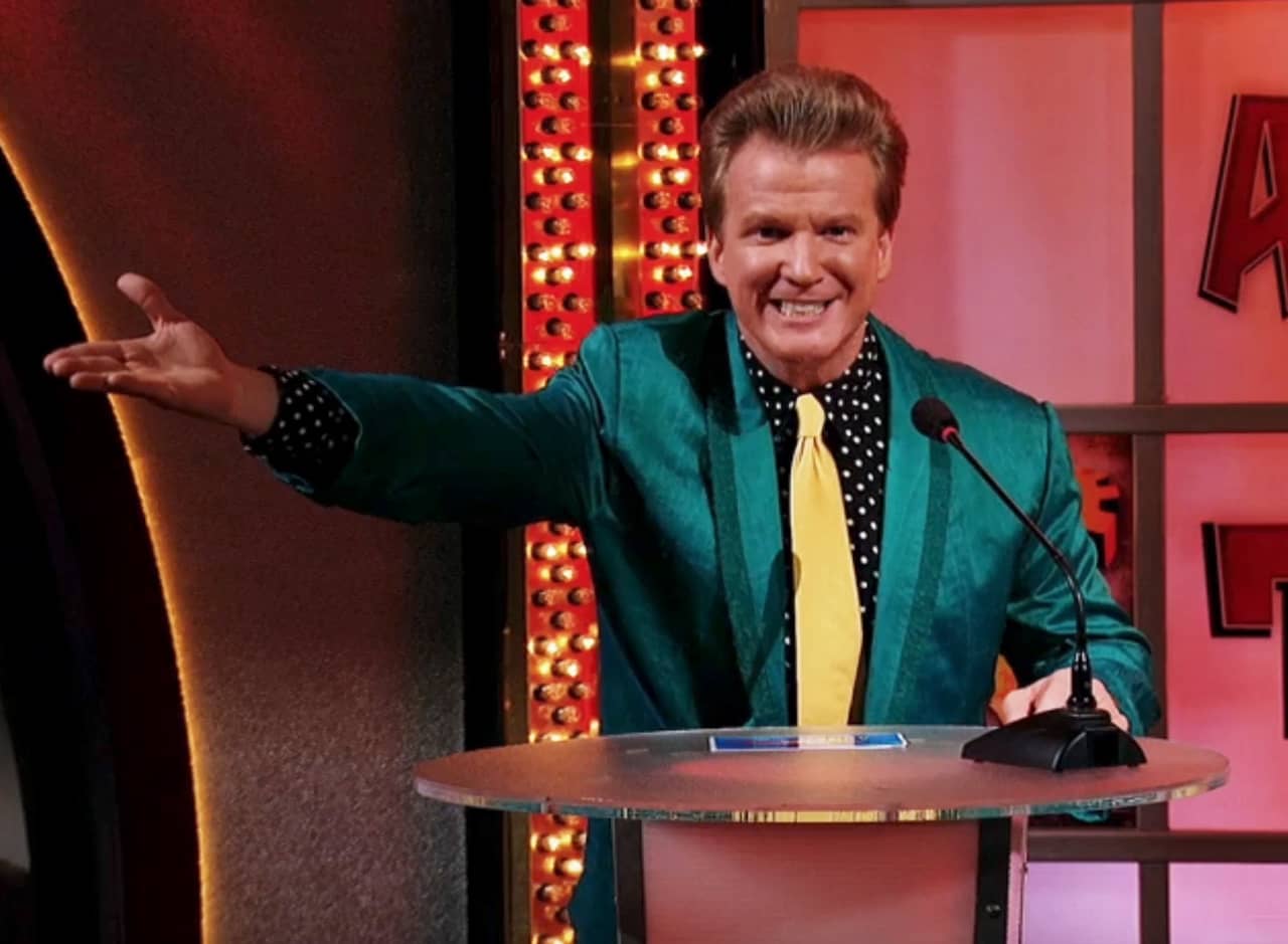 host in shiny green jacket