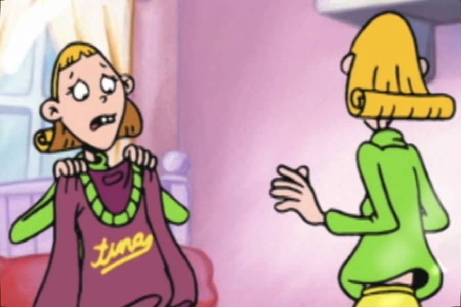 Tina looking sad, holding up a sweatshirt