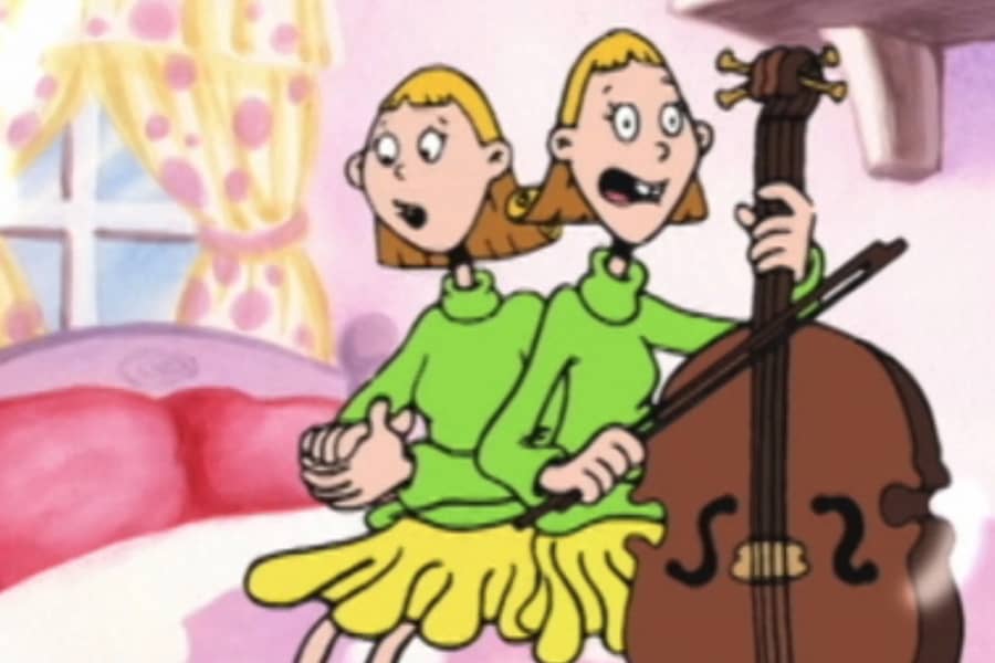 Gina and Tina sitting on the bed, Tina is holding a cello
