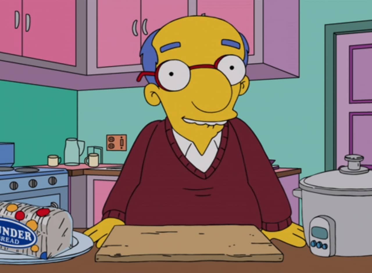 Kirk Van Houten in a kitchen with a loaf of bread and a rice cooker