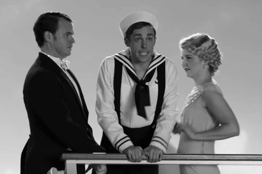 a sailor sings against a ship railing in between a man and woman