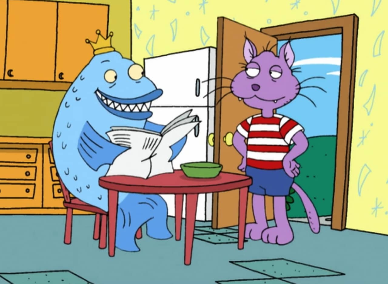 Daggermouth, a fish wearing a crown, reads the paper and smiles at Boom Boom, a purple cat in a striped shirt
