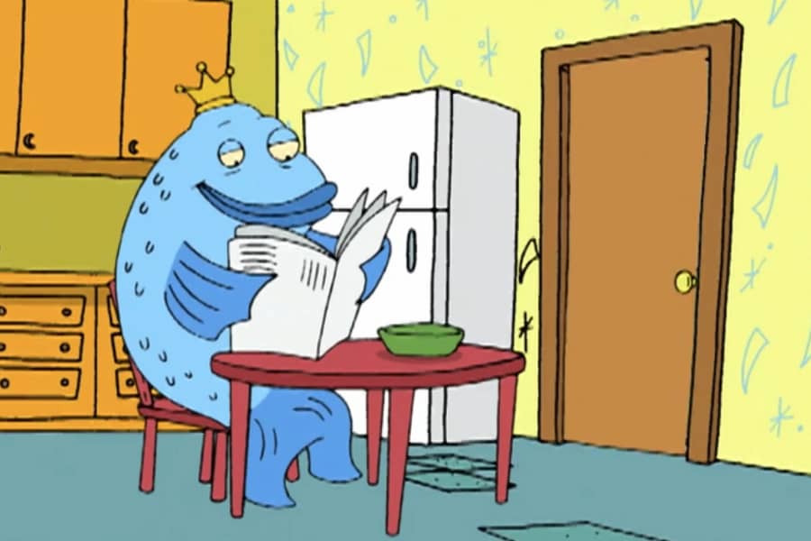 Daggermouth sits alone at a table reading the paper