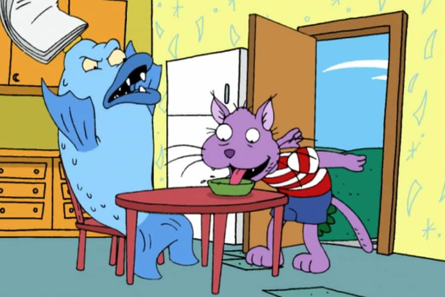 Daggermouth throws his newspaper as Boom Boom laps up milk from a bowl on the table