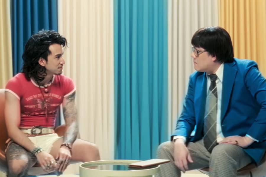 host talking to the same man but without his jacket on