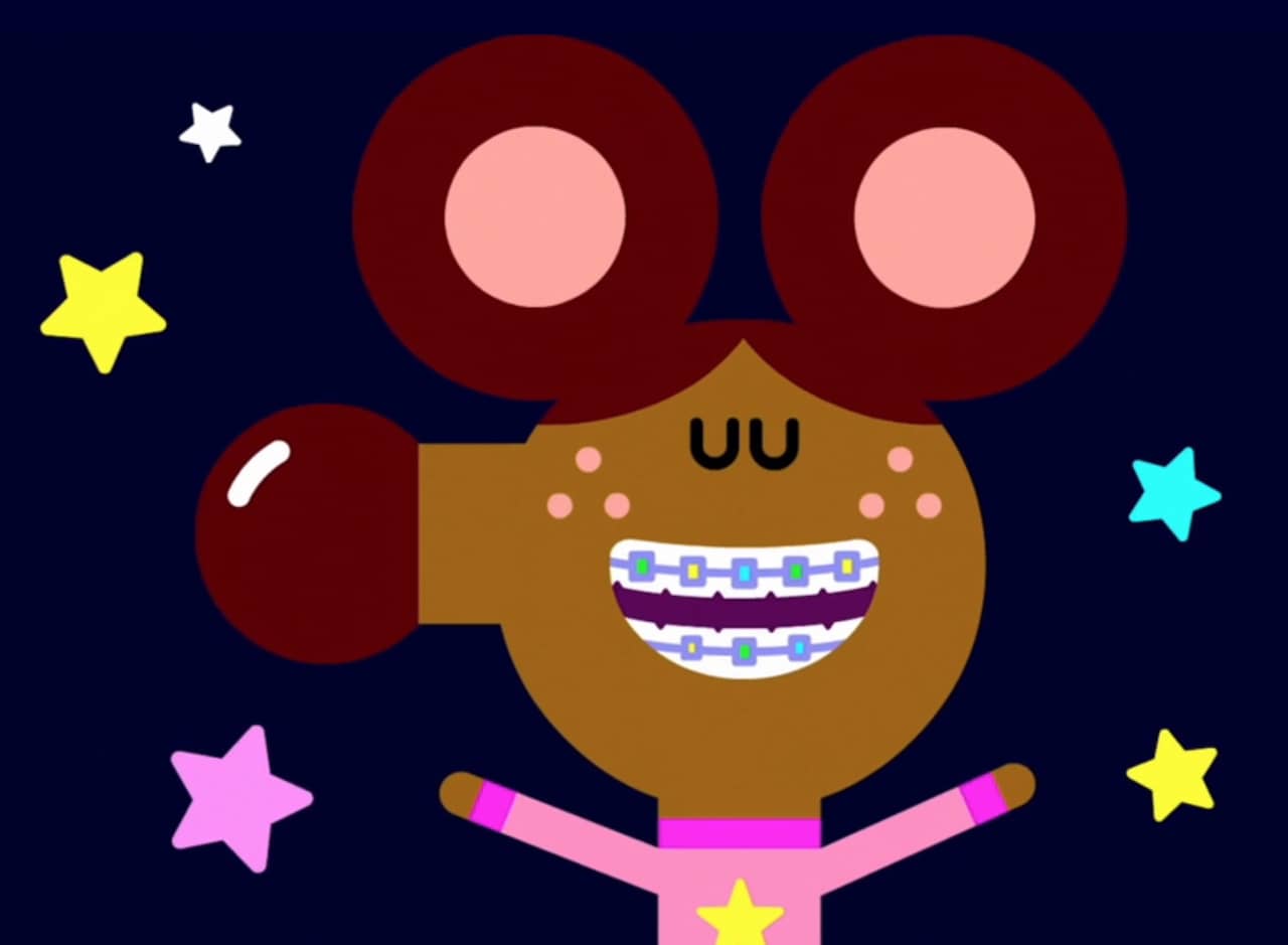 young girl smiling big with braces