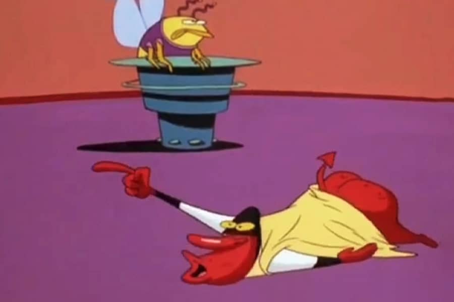 Red Guy laying on the ground and pointing