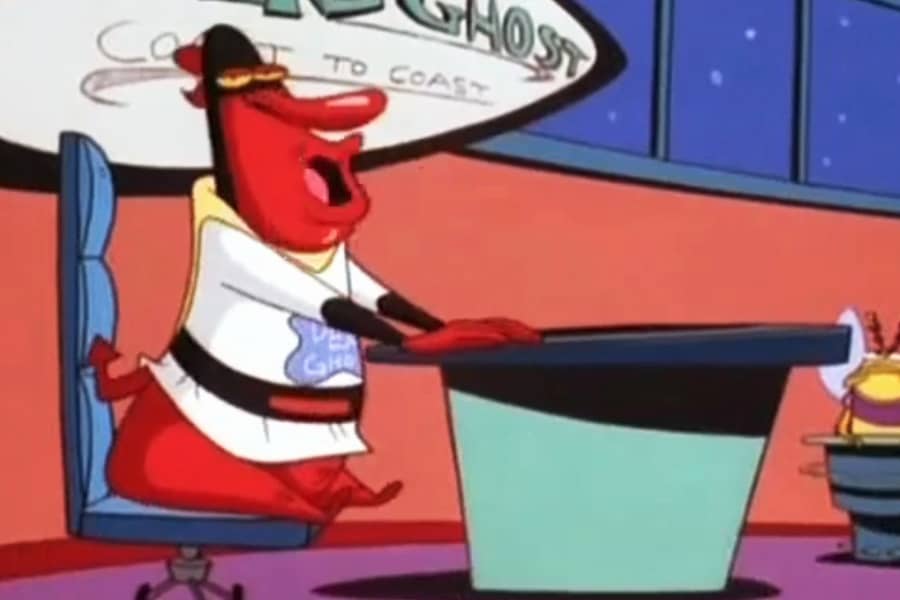 Red Guy at his talk show desk