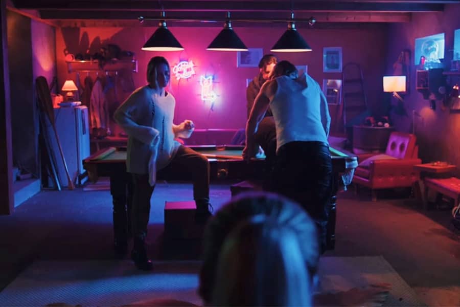 three home invaders in the neon-lit basement
