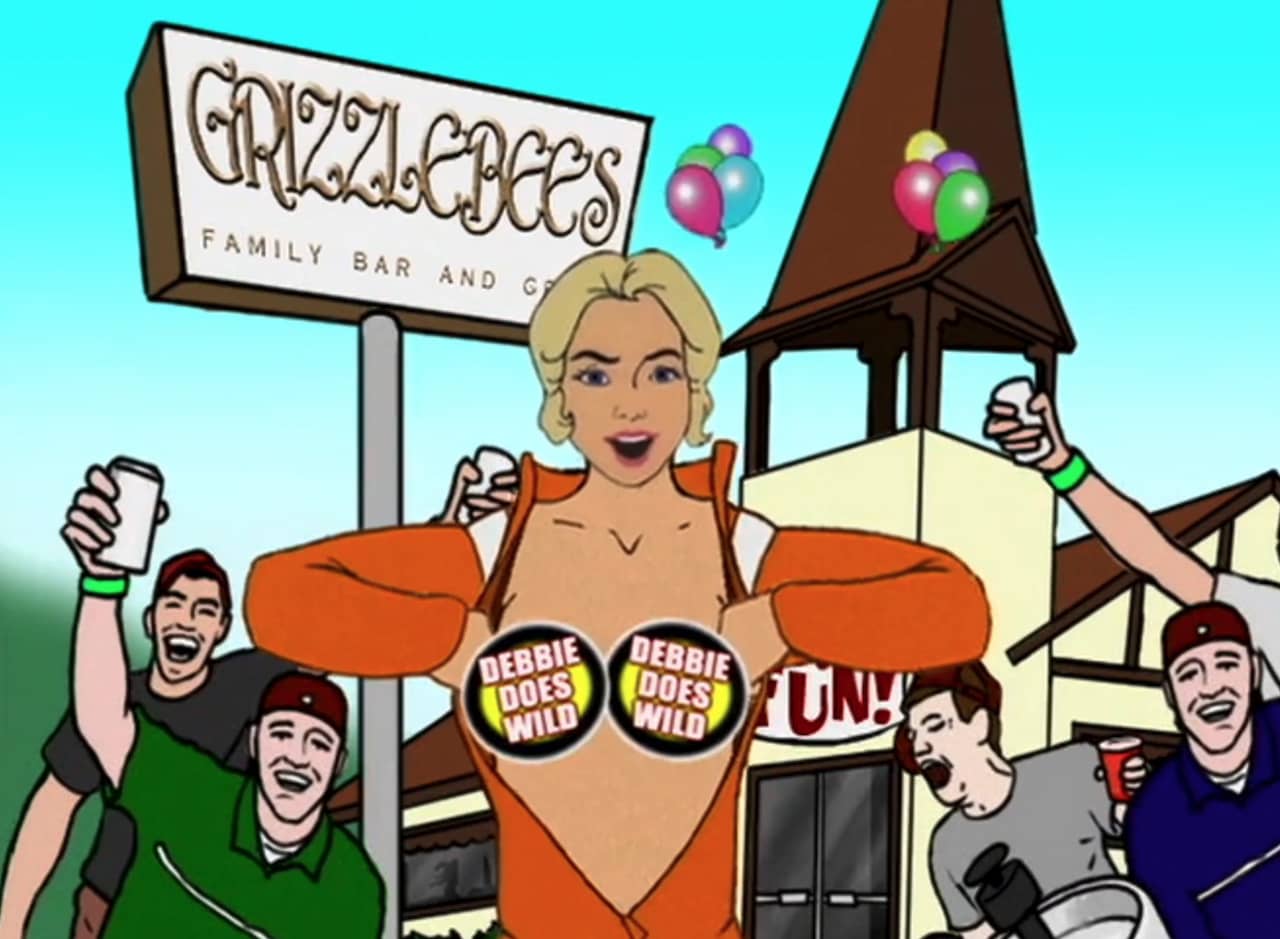 Debbie opening her orange jumpsuit, breats covered with logos, with partying dudes in front of a Grizzlebee’s restaurant
