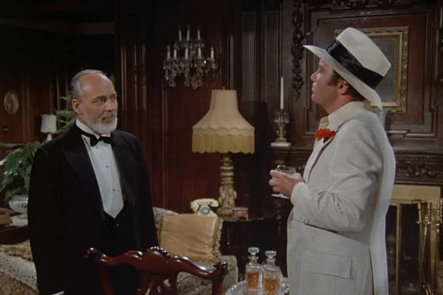 Lucerne speaks with an older man in a tuxedo