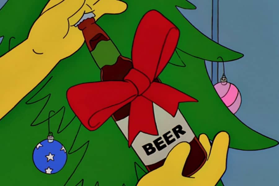 hands hold up a beer bottle with a red bow on it