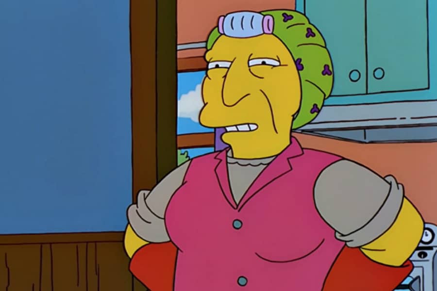an old lady with a bonnet over curlers and two oven mitts on