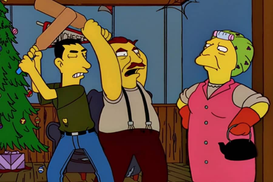two guys holding up wooden paddles at the old woman