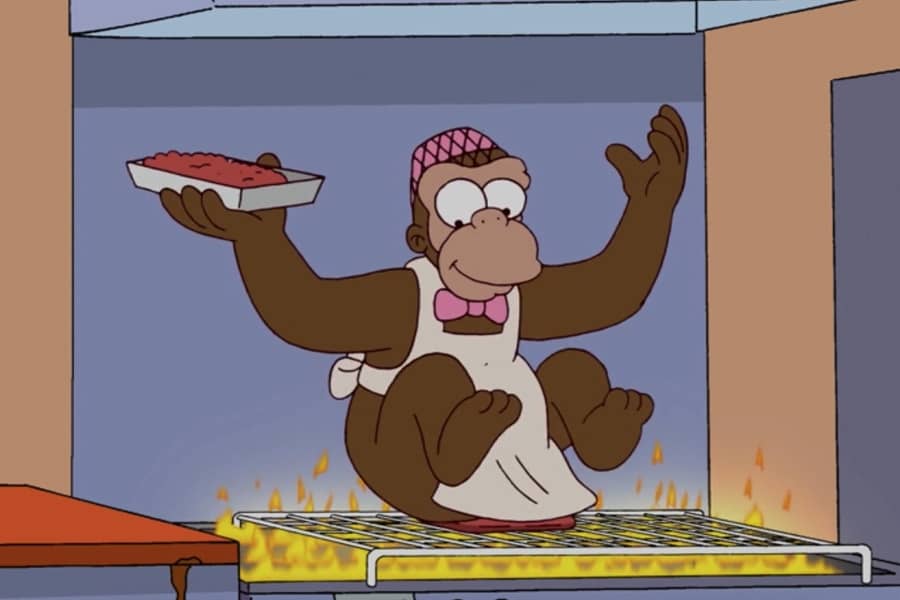a monkey rubbing its butt on the burger grill
