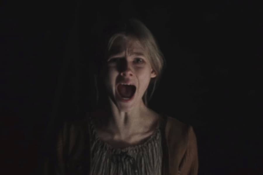 young girl screaming in the dark