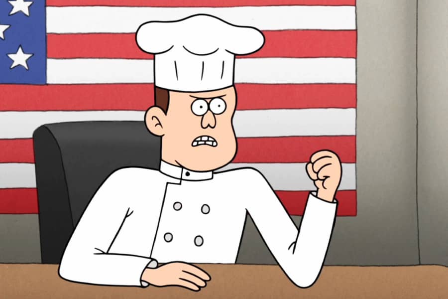 a chef balls his fist in front of an American flag