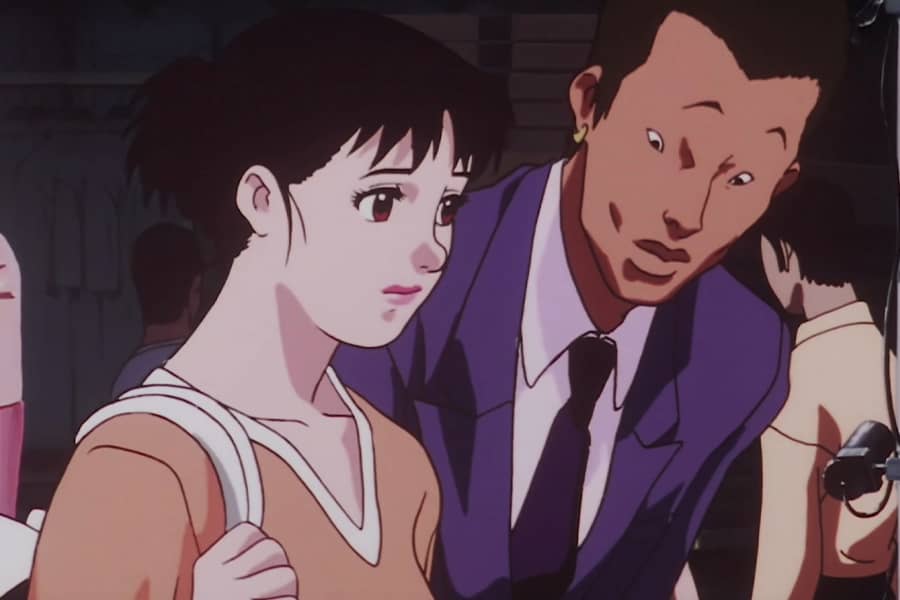 a man talking to Yoko on the street