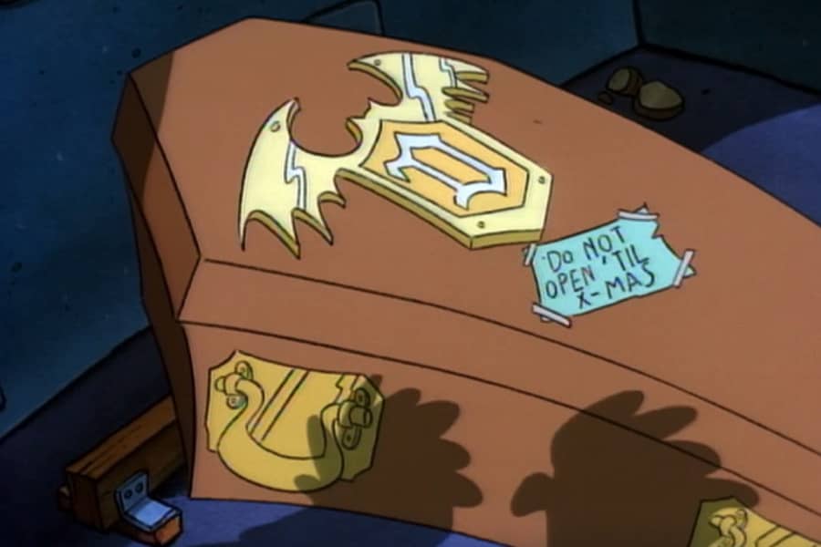 a coffin with a sign that says “Don’t open until X-mas”