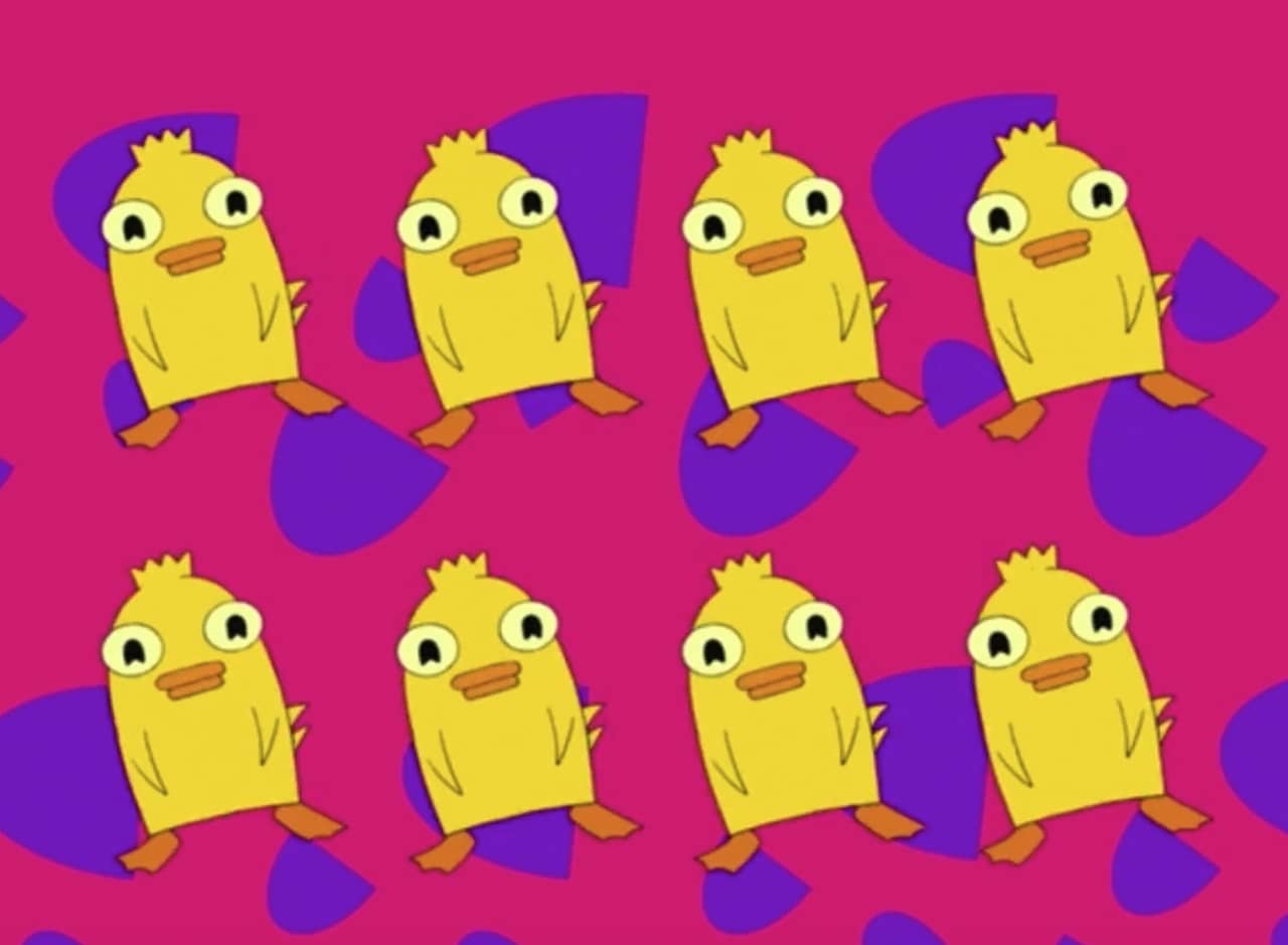eight Ducky Momos, a round yellow duck, dancing in front of a brightly colored patterned background