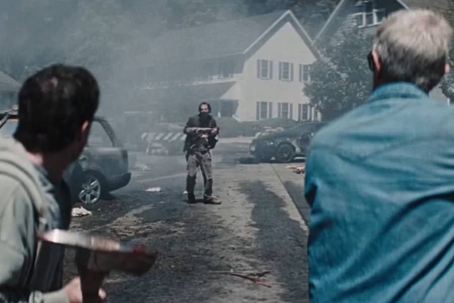 Knoxville and Hutcherson approach a zombie on a trashed street