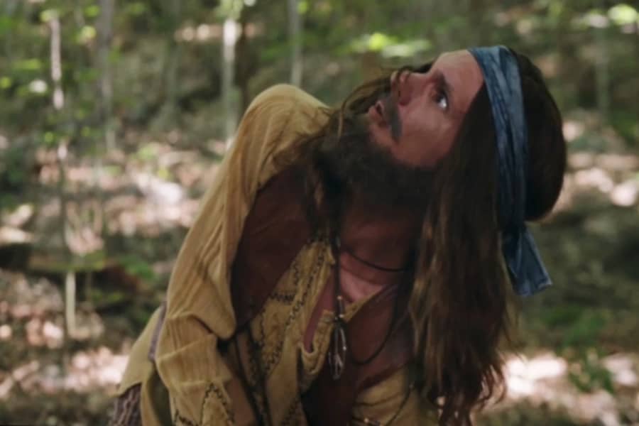 hippie man looking up at the sky