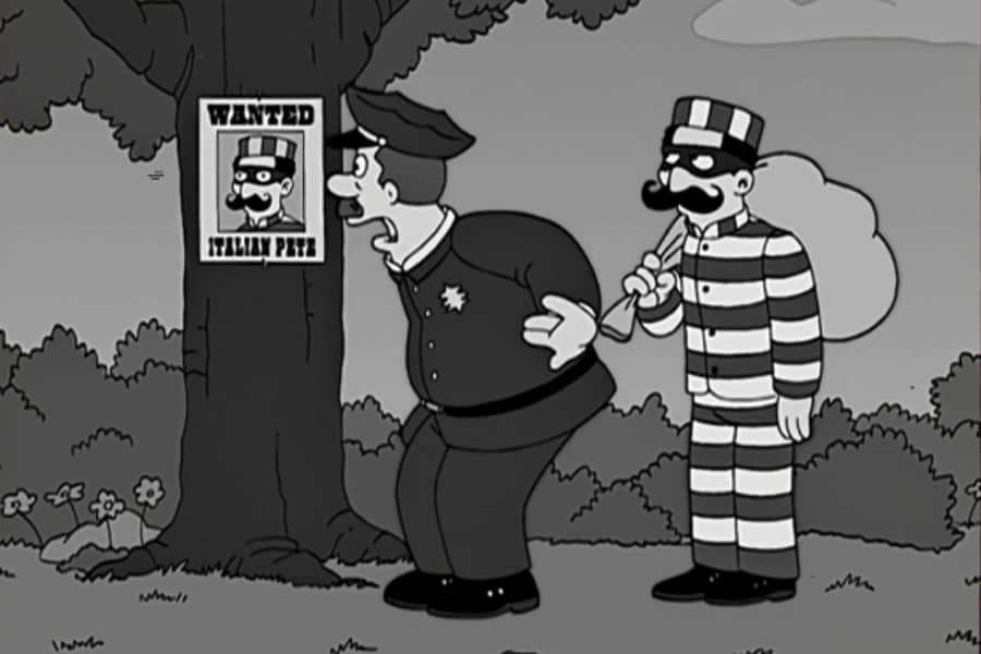 Officer Joe gasping at wanted poster of Italian Pete while standing next to him