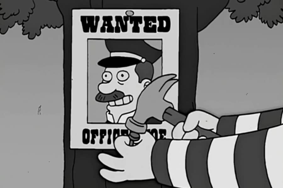 Pete nailing up a wanted poster of Officer Joe