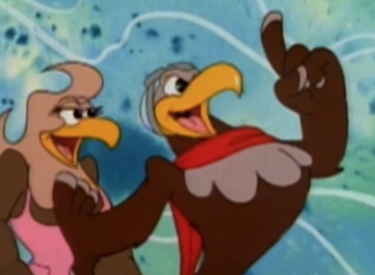 Edgar Eagle, wearing a red scarf, and protecting a woman eagle