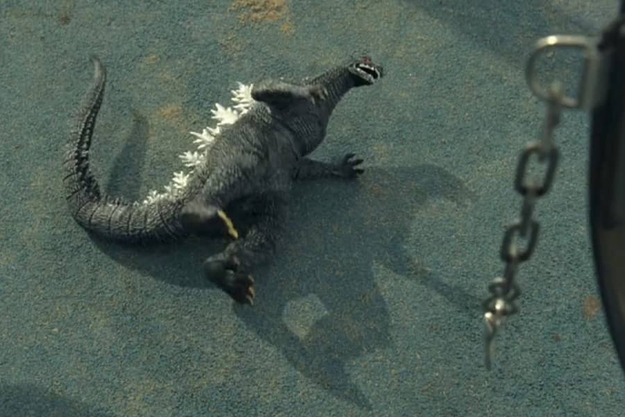 Godzilla toy on the pavement