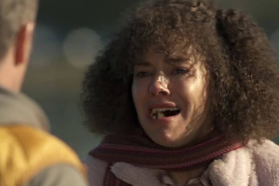 woman cries with fruit in her mouth