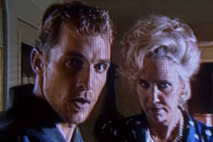 Ed and his mom, who looks angry, looking at the camera