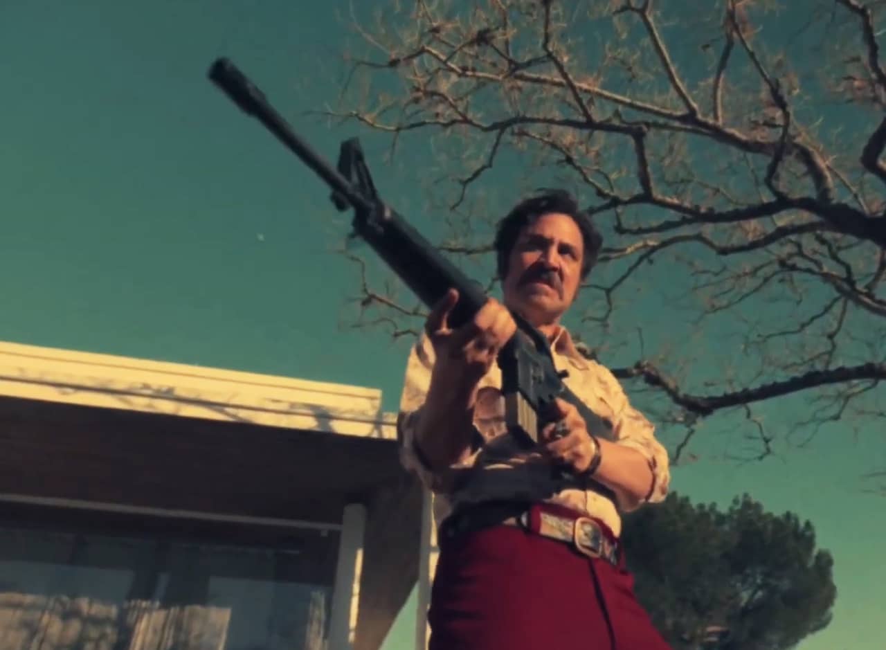 Lonny Flash outside a house, holding a giant gun