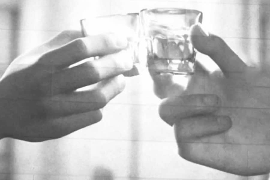 two hands toasting glasses